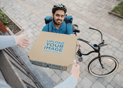 Mockup of a Smiling Man Delivering a Pizza Box