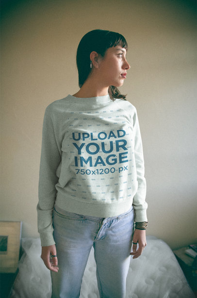Woman Wearing a Crewneck Sweatshirt Template in her Room a18996