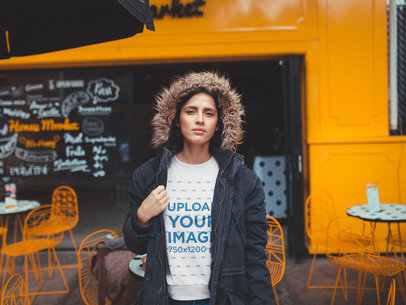 White Woman Wearing a Crewneck Sweatshirt Mockup Outside an Orange Coffee Shop