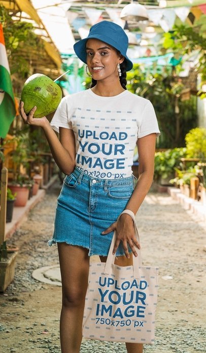 Gildan T-Shirt and Tote Bag Mockup of a Smiling Woman With a Coconut