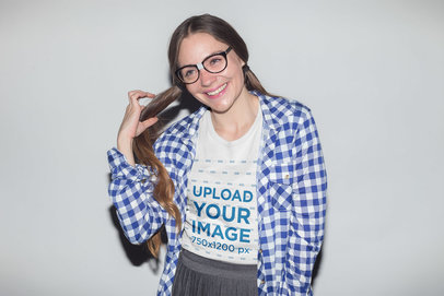 Nerdy Woman with Ponytails Wearing a T-Shirt Mockup Against a White Wall