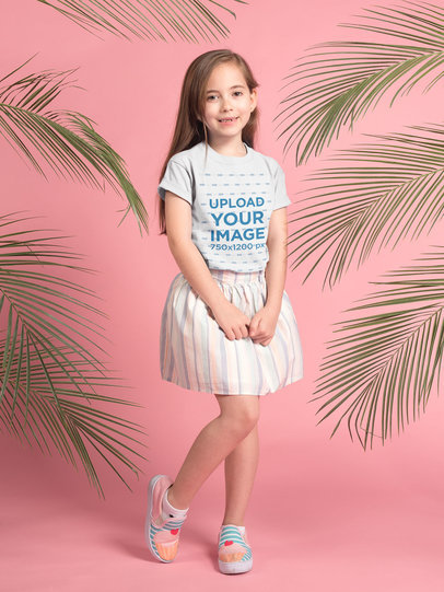 Pretty Little Girl Wearing a T-Shirt Mockup Standing Near Plants