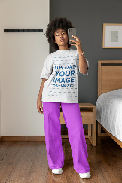 Round-Neck T-Shirt Mockup of a Woman with Afro Hairstyle Taking a Mirror Selfie