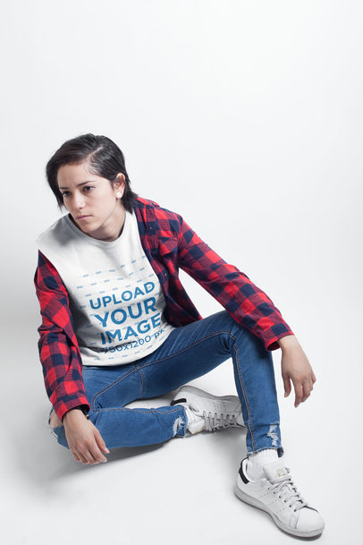 Woman Sitting in a White Room Wearing a T-Shirt