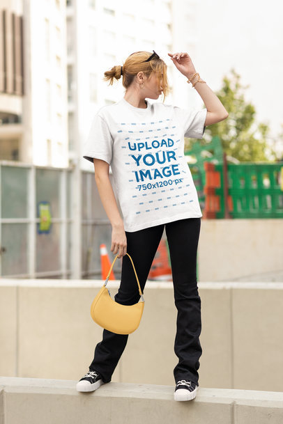 Round-Neck Tee Mockup Featuring a Woman Posing by the Street