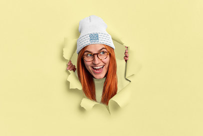Beanie Mockup Featuring a Cheerful Woman Coming Through a Torn Paper Hole m3458 r-el2