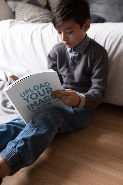 Boy Reading a Book Mockup Sitting Against his Bed