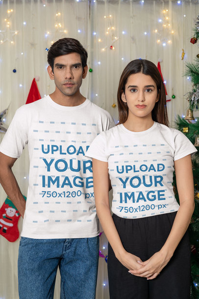 Gildan Tee Mockup Featuring a Couple Posing in a Christmas Setting