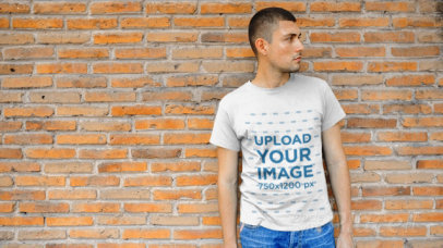 Young Man Wearing a T-Shirt Video Leaning Against a Brick Wall