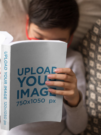 Boy with Red Glasses Reading a Book Mockup Sitting on a Couch
