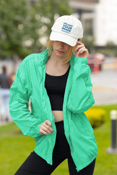 Dad Hat Mockup Featuring a Serious Woman Posing by the Street