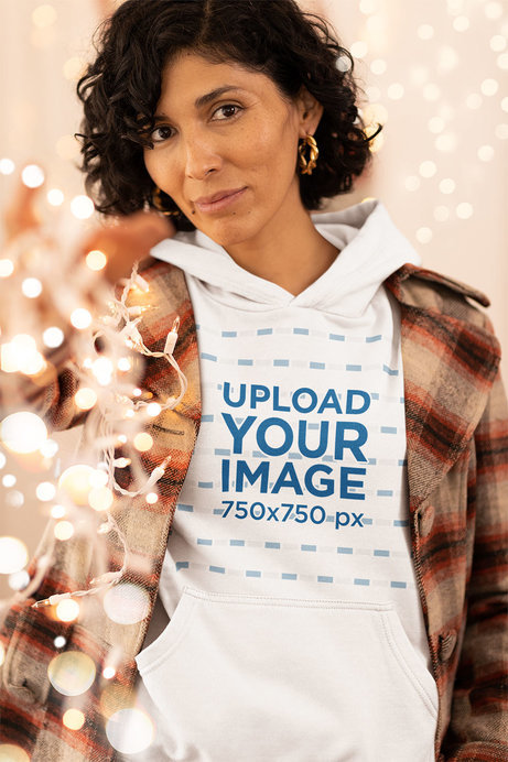 Hoodie Mockup Featuring a Smiling Woman Holding Christmas Lights
