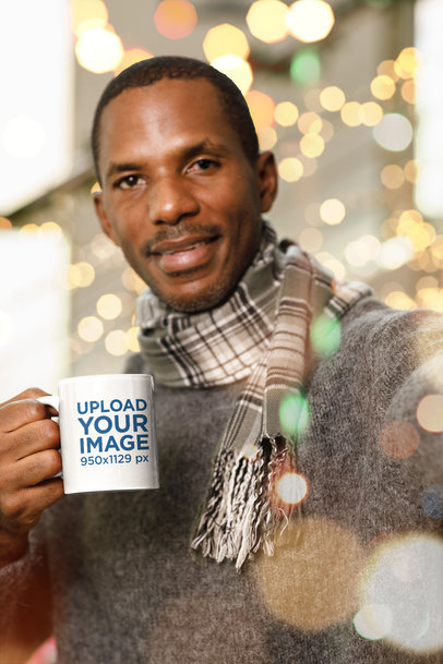 Mockup of a Smiling Man Holding a Coffee Mug in a Christmas Setting