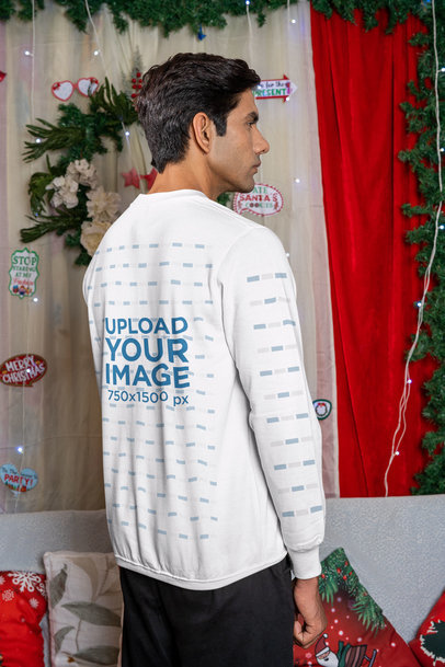 Back-View Mockup of a Man Posing in a Sweatshirt by Christmas Decorations