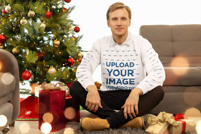 Sweatshirt Mockup of a Man Sitting in a Christmas-Decorated Living Room