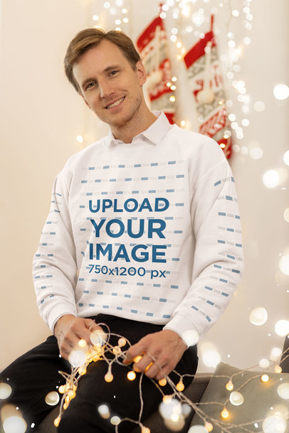 Crewneck Sweatshirt Mockup of a Smiling Man Holding Xmas Lights