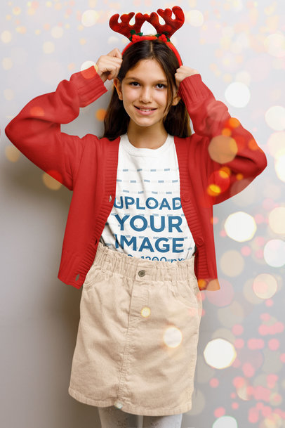 Round-Neck Tee Mockup of a Happy Girl Wearing a Reindeer Ears Headband