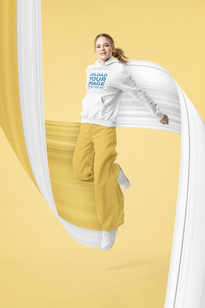 Pullover Hoodie Mockup of a Smiling Woman Doing a Small Jump 