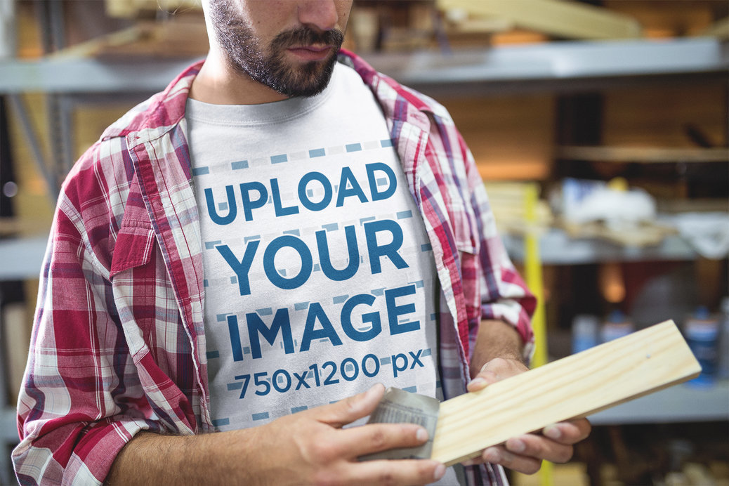 Carpenter Wearing a T-Shirt Mockup while Sanding a Piece of Wood