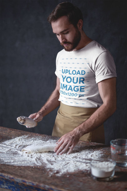 Baker Wearing a T-Shirt Mockup and an Apron while Working the Dough