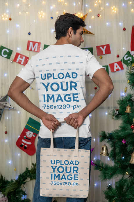 Back-View Gildan T-Shirt Mockup of a Man Carrying a Tote Bag in a Christmas Setting