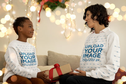 Sweatshirt Mockup of a Boy and a Woman Exchanging a Christmas Present