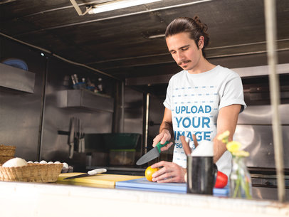 Man Wearing a T-Shirt Mockup Cooking in his Food Truck
