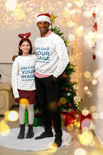 Sweatshirt Mockup of a Father and Daughter Posing by a Christmas Tree