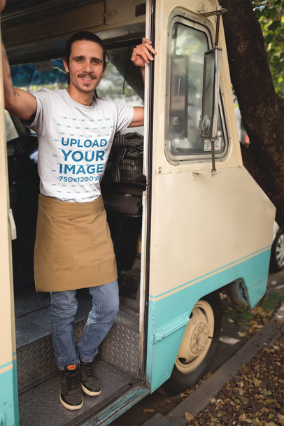 Man Smiling Wearing a T-Shirt Mockup Leaning Against his Food Truck Door