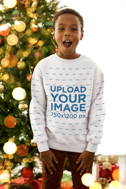 Sweatshirt Mockup of a Surprised Kid Standing by a Christmas Tree
