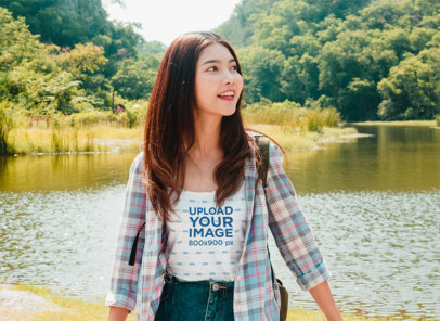 T-Shirt Mockup of a Cheerful Woman Posing by a Lake m8970 r-el2