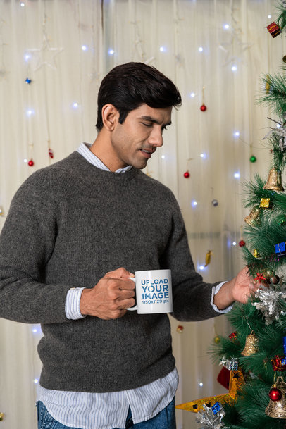 Coffee Mug Mockup Featuring a Man Looking at a Christmas Tree
