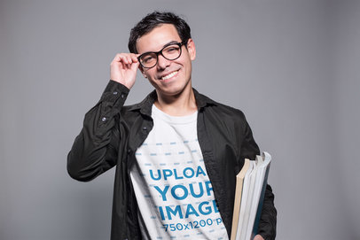 Nerd Guy Wearing a T-Shirt Mockup While Carrying Books