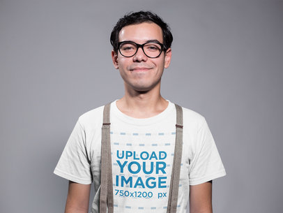Smart Geek Guy Wearing a T-Shirt Mockup in a Gray Room