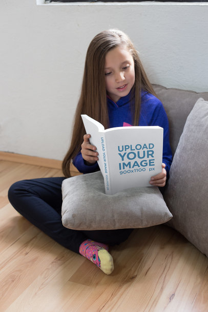 Mockup Featuring a Pretty Girl Reading a Book While Sitting on the Floor