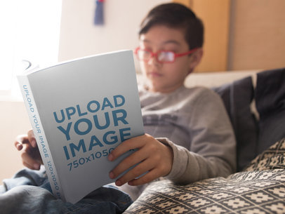 Mockup of a Book Read by a Boy in His Bed
