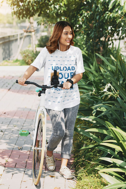 Heathered T-Shirt Mockup of a Smiling Woman Walking With a Bike m12994 r-el2