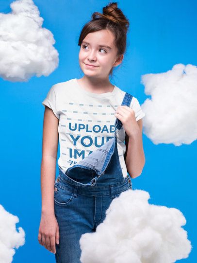 Mockup of a Girl Wearing a Round Neck T-Shirt Mockup in a Room with Clouds