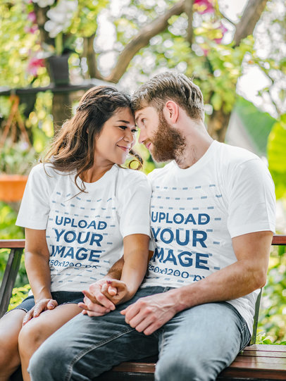 T-Shirt Mockup of a Smiling Couple Sitting on a Park Bench