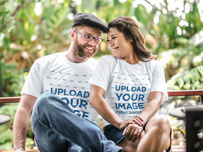 T-Shirt Mockup Featuring a Happy Couple Sitting on a Bench and Hanging Out
