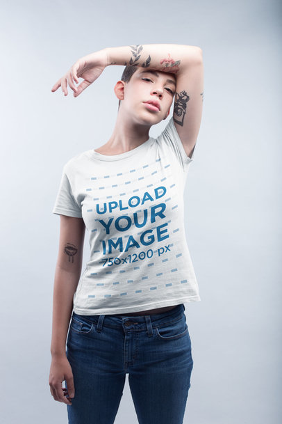 Tattooed Woman Wearing a Tshirt Template in a White Room