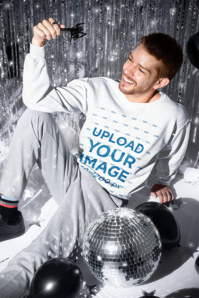 Sweatshirt Mockup Featuring a Cheerful Man Posing in a New Year-Themed Party Set