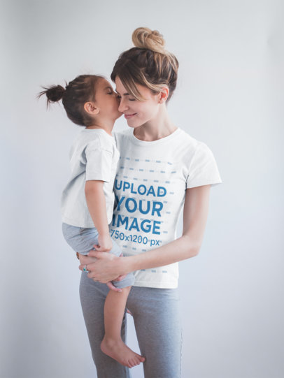 Woman Wearing a T-Shirt Mockup Being Kissed by her Daughter