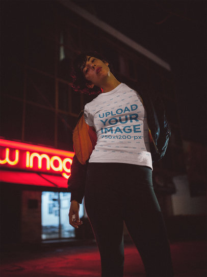 Woman Wearing a T-Shirt Mockup Outside a Restaurant at Night