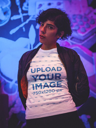 Mockup of a Woman Wearing a T-Shirt Standing in a Purple Room