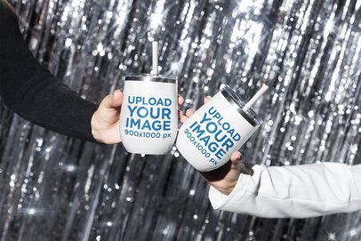 Mockup of Two Women Holding Wine Tumblers Against a Sparkly Background m30508