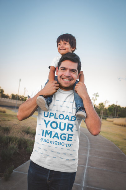 Dad Wearing a T-Shirt Mockup While Carrying his Son