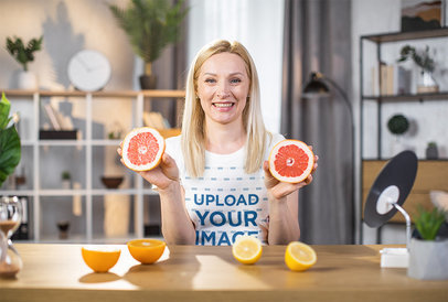 T-Shirt Mockup Featuring a Cheerful Woman Holding Grapefruit Slices m22301 r-el2