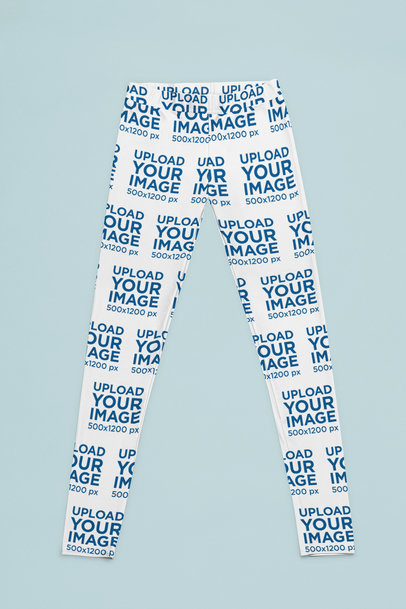 Mockup of a Pair of Sublimated Leggings Placed over a Solid Surface