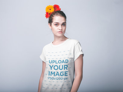 Woman with Flowers on her Head Wearing a T-Shirt Mockup Against a White Wall